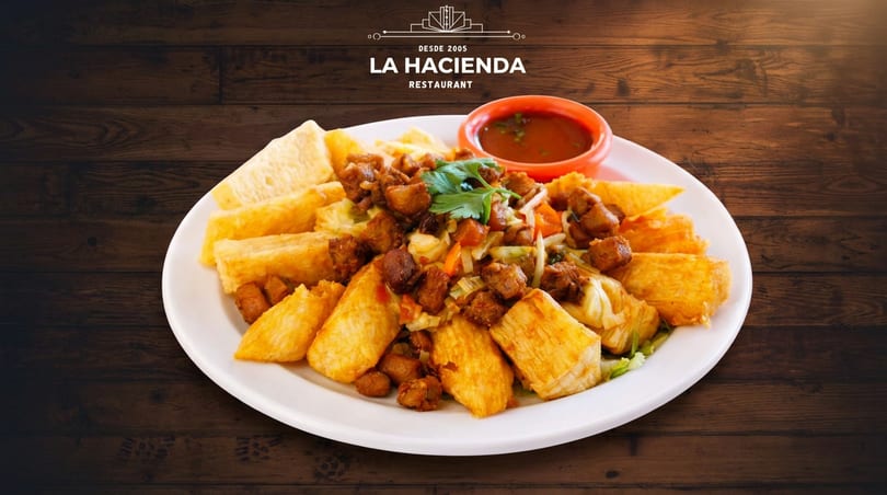 La Hacienda's fried yuca and crispy pork chunks with vegetables and red sauce.